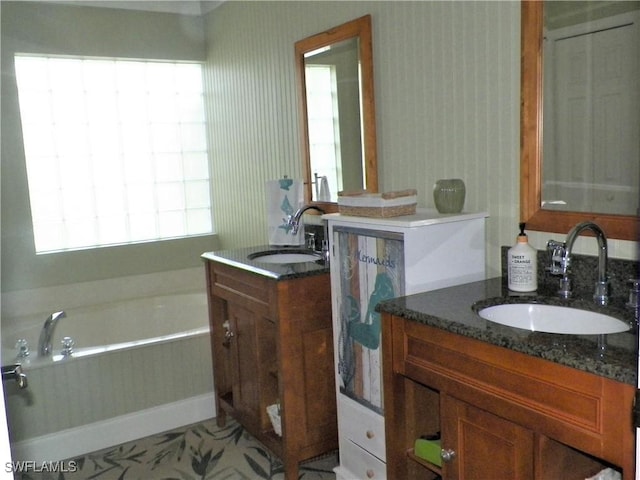 bathroom featuring vanity and a tub