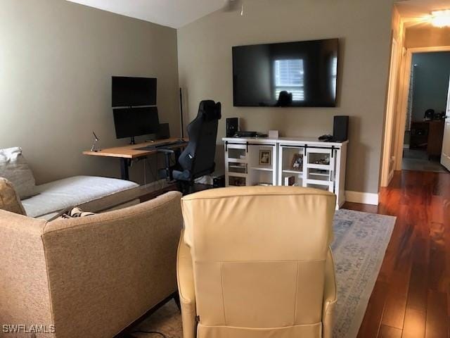 living room featuring dark hardwood / wood-style flooring and lofted ceiling