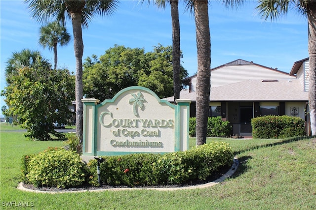 community / neighborhood sign with a yard