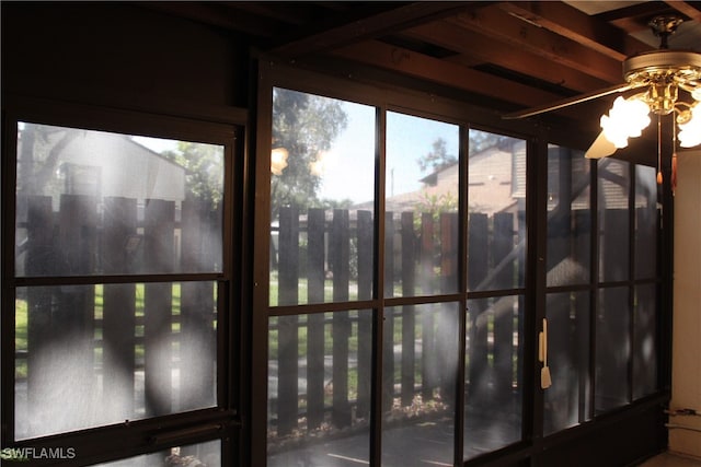 unfurnished sunroom featuring ceiling fan