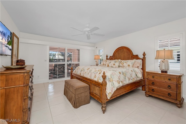 tiled bedroom with access to outside and ceiling fan