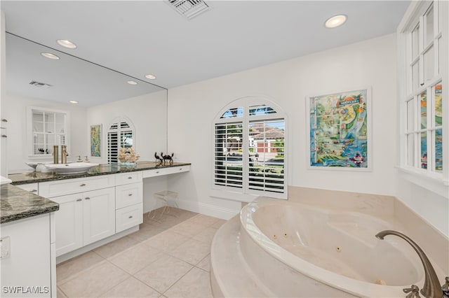 bathroom featuring vanity, tiled tub, and tile patterned floors