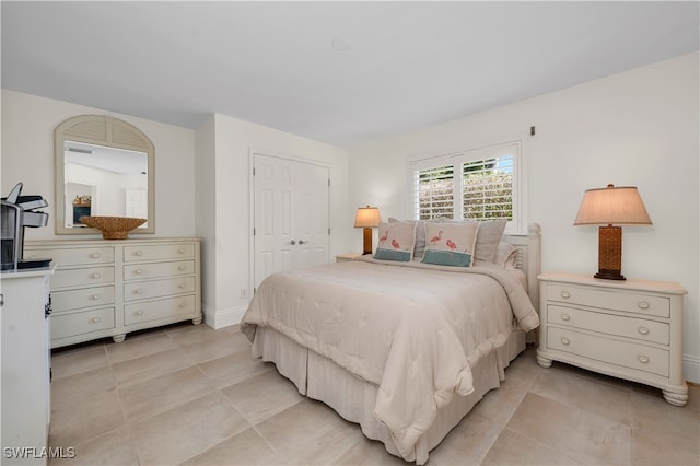 tiled bedroom with a closet