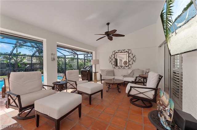 living room featuring tile patterned flooring, ceiling fan, and vaulted ceiling