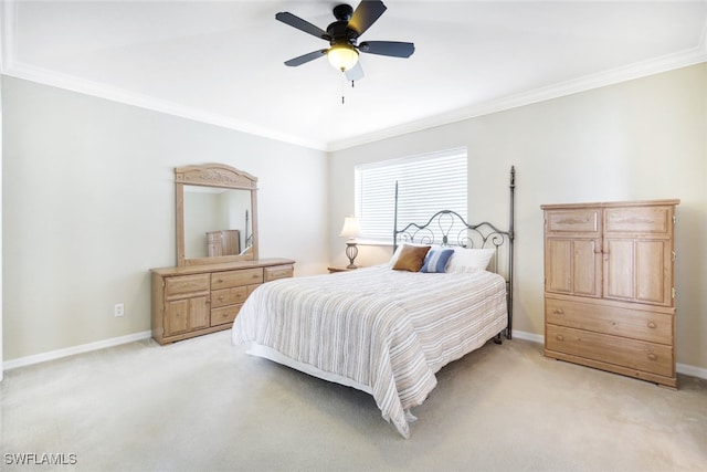 carpeted bedroom featuring crown molding and ceiling fan