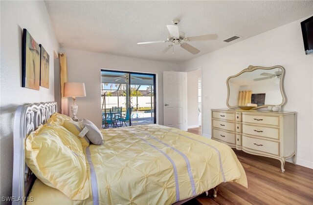 bedroom featuring access to outside, a textured ceiling, hardwood / wood-style floors, and ceiling fan