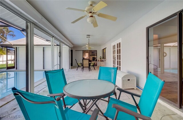 sunroom featuring ceiling fan