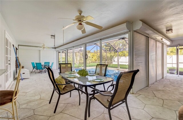 sunroom / solarium featuring ceiling fan and plenty of natural light