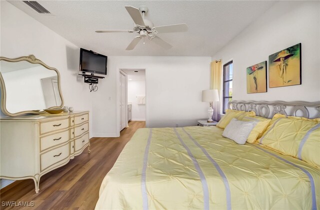 bedroom with ceiling fan and dark hardwood / wood-style floors