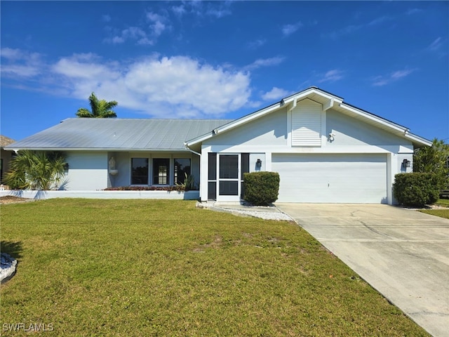 ranch-style house featuring a garage and a front lawn