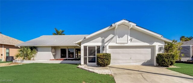 ranch-style house with a garage, a front lawn, and central AC