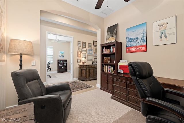 home office with light carpet and ceiling fan