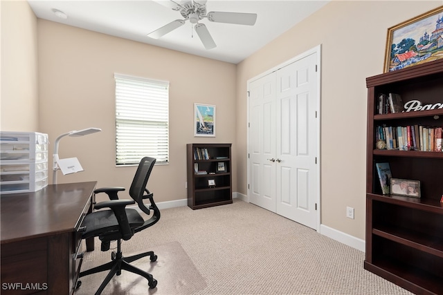 home office featuring ceiling fan and light carpet