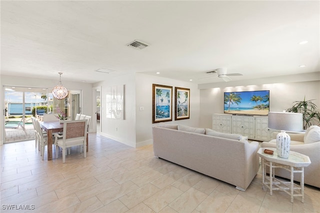 living area with a ceiling fan, recessed lighting, visible vents, and baseboards