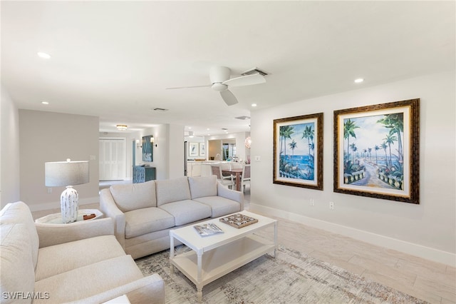 living area with ceiling fan, recessed lighting, visible vents, and baseboards