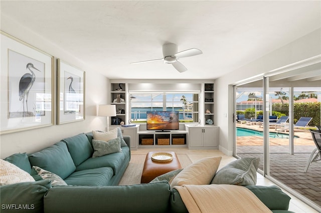 living area featuring a ceiling fan and built in features