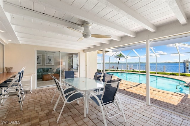 interior space with a water view and ceiling fan