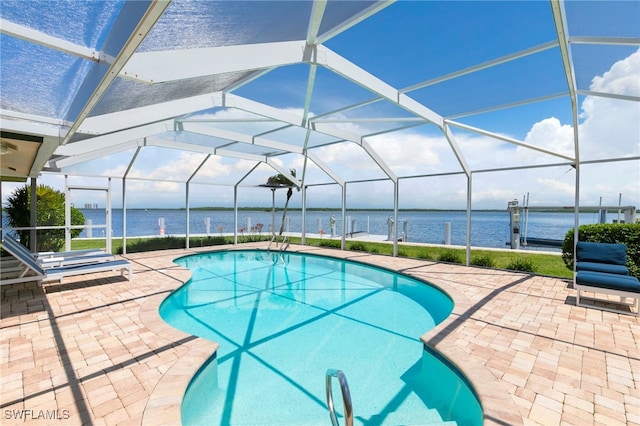 pool featuring a water view, a patio area, and glass enclosure