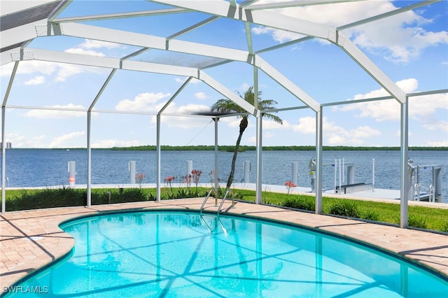 pool with a patio area, a lanai, and a water view