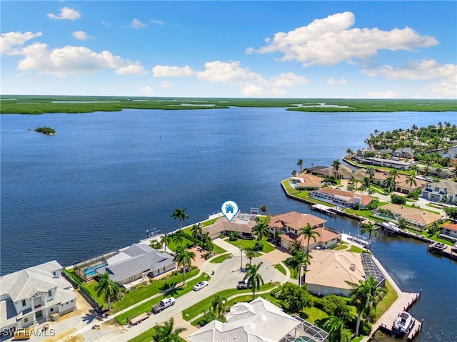 drone / aerial view featuring a residential view and a water view