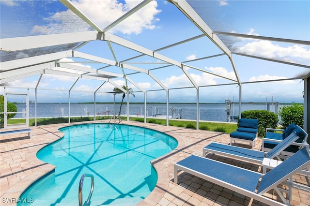 pool featuring a lanai, a water view, and a patio