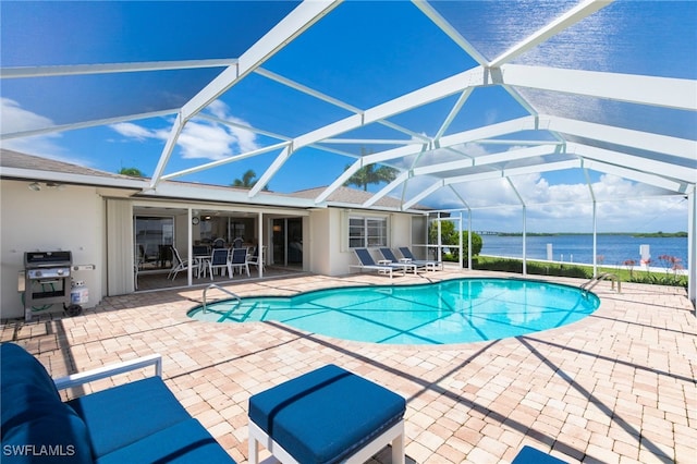 outdoor pool featuring a water view, a grill, a lanai, and a patio