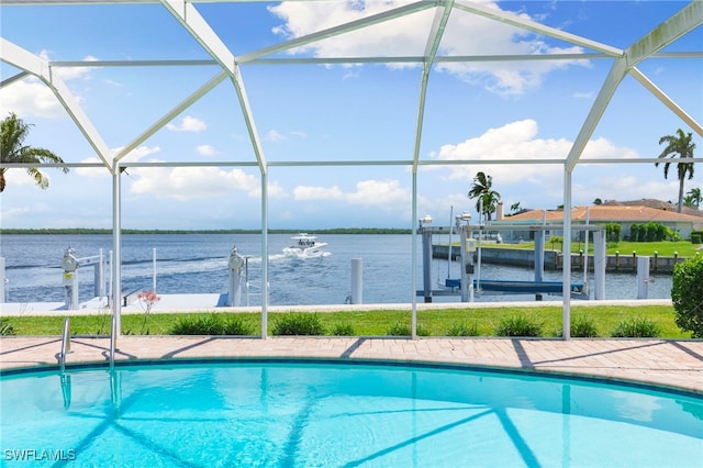 outdoor pool featuring a boat dock, a water view, boat lift, and a lanai