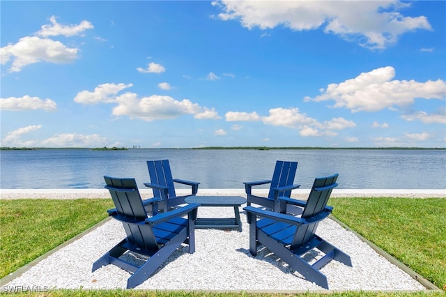 view of patio featuring a water view and a fire pit