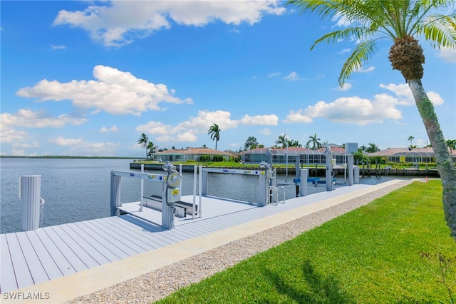 view of dock with a water view, boat lift, a residential view, and a yard