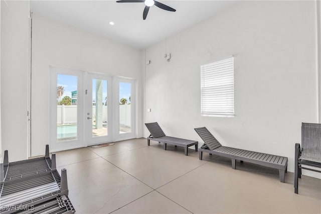 living area with finished concrete floors, a ceiling fan, and recessed lighting