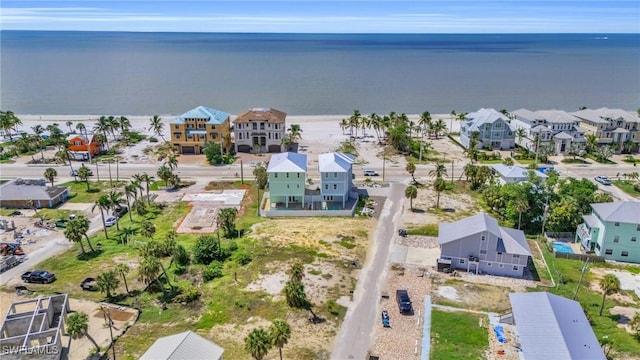 drone / aerial view with a water view and a residential view