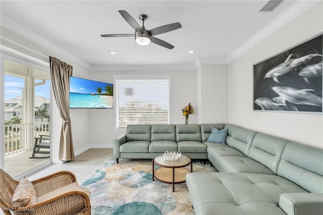 living area featuring ornamental molding, a healthy amount of sunlight, visible vents, and light wood finished floors