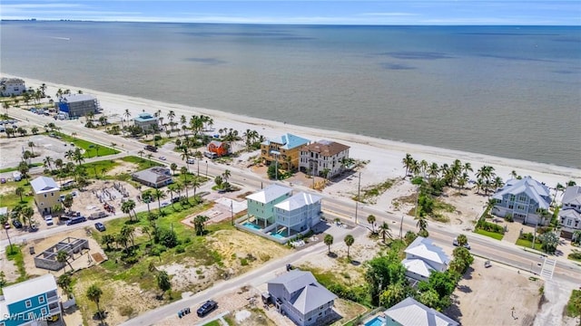 drone / aerial view featuring a water view and a beach view