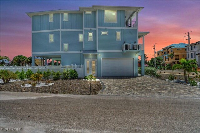 view of front of property featuring a garage and a balcony