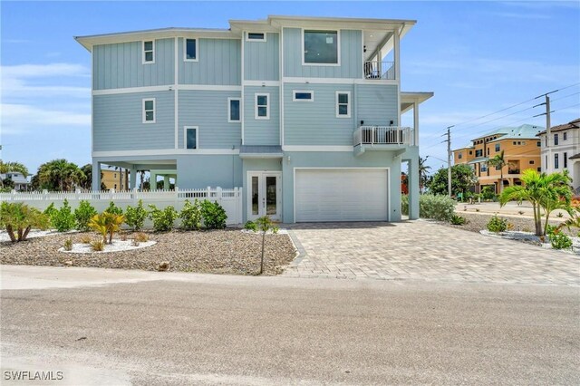 view of front of home featuring a garage and a balcony