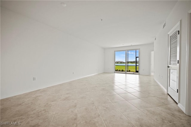 unfurnished room featuring light tile patterned flooring and visible vents