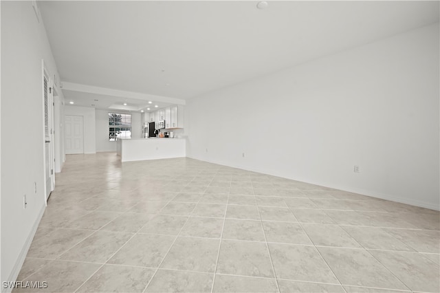 unfurnished living room with light tile patterned floors