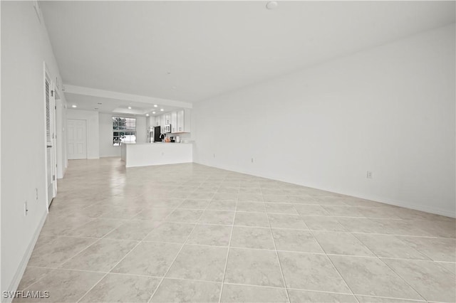 unfurnished living room with light tile patterned flooring and recessed lighting