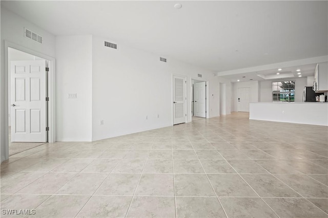 unfurnished living room featuring recessed lighting, visible vents, and light tile patterned flooring