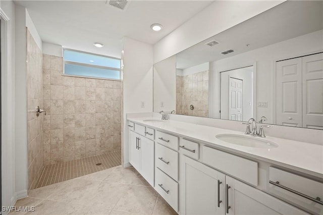 full bath featuring a walk in shower, a sink, and visible vents