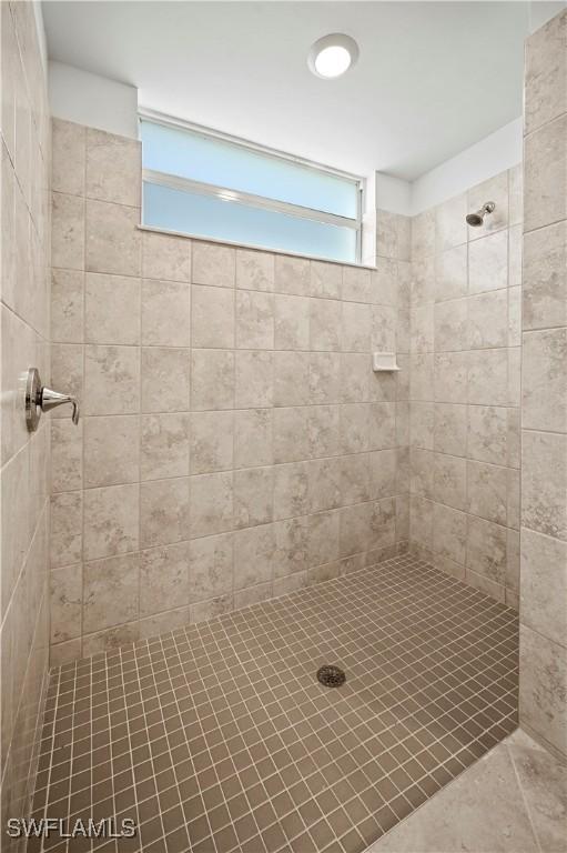 bathroom with tiled shower