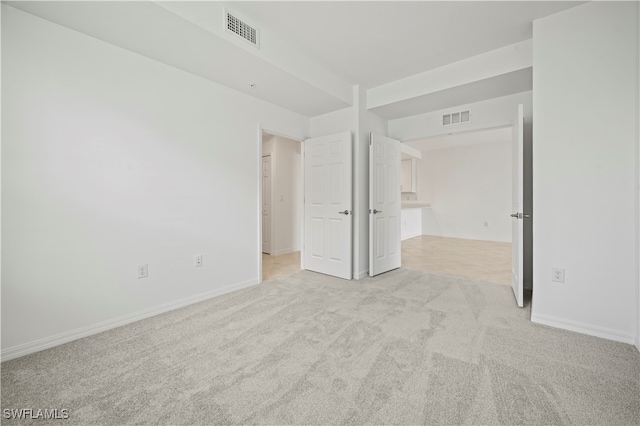 unfurnished bedroom with light colored carpet