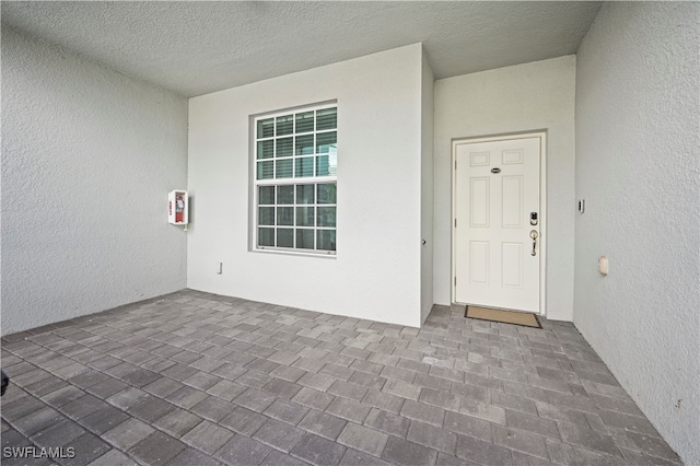 property entrance featuring a patio area