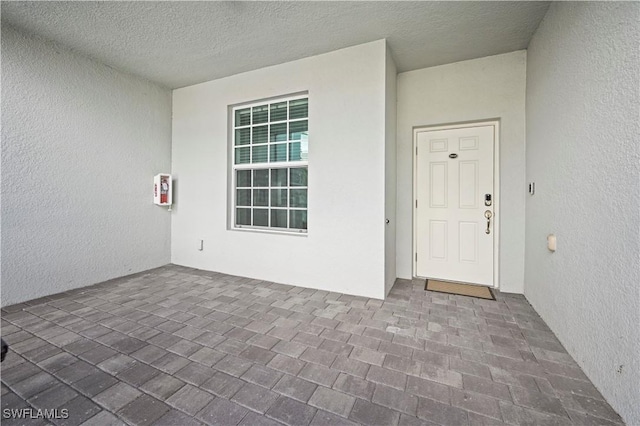 entrance to property with a patio