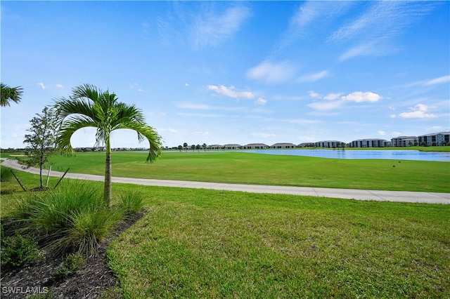 view of community with a lawn and a water view