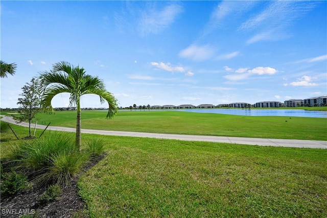 surrounding community featuring a water view and a yard