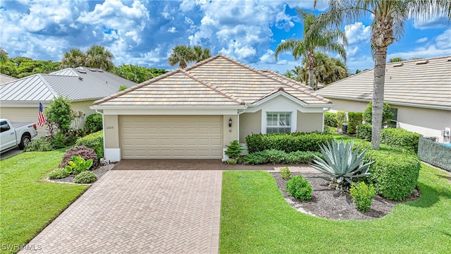 view of front of house with a garage and a front lawn