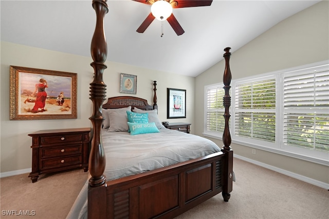 bedroom with ceiling fan, vaulted ceiling, and light carpet