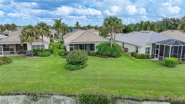 exterior space featuring a lanai and a lawn