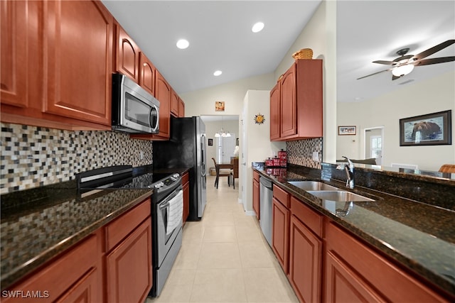 kitchen featuring tasteful backsplash, appliances with stainless steel finishes, sink, and dark stone countertops